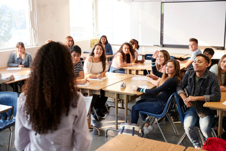 Teacher explaining addiction prevention lesson plans to students