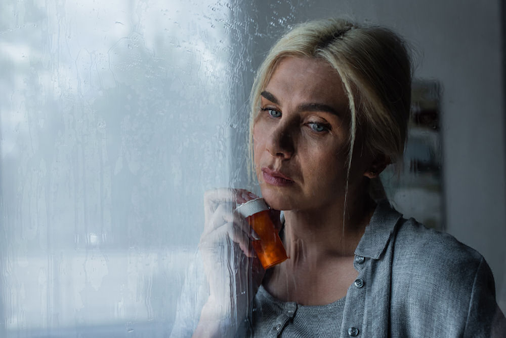 Woman Holding a Bottle Containing a Party Drug