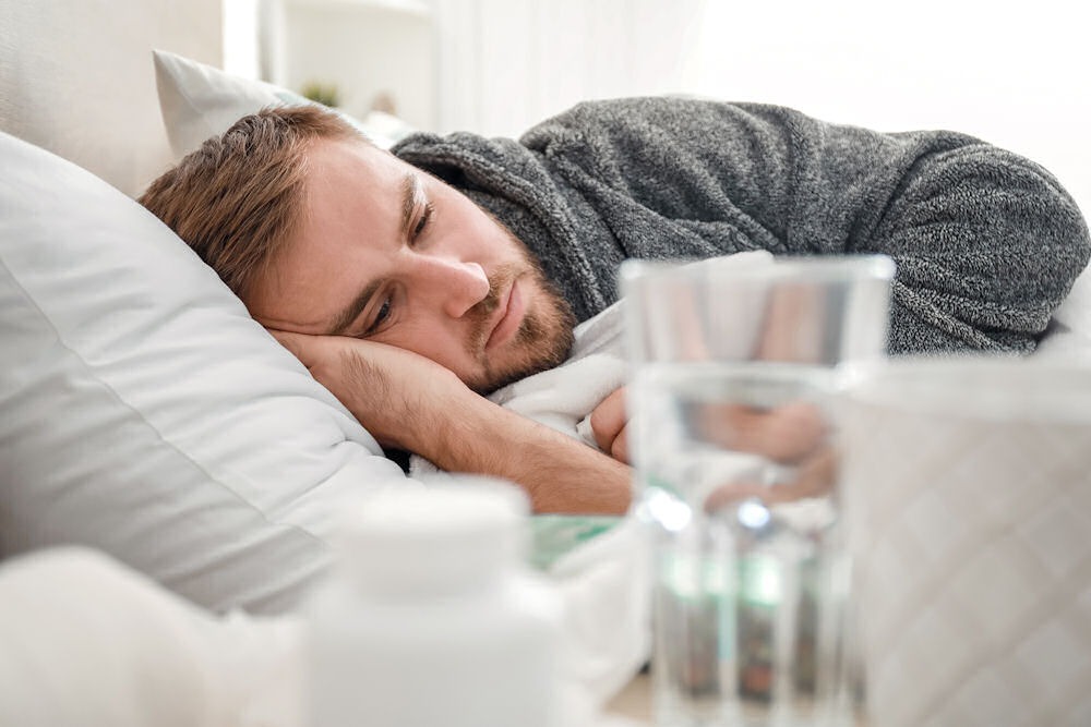 man laying in bed thinking how long is detox